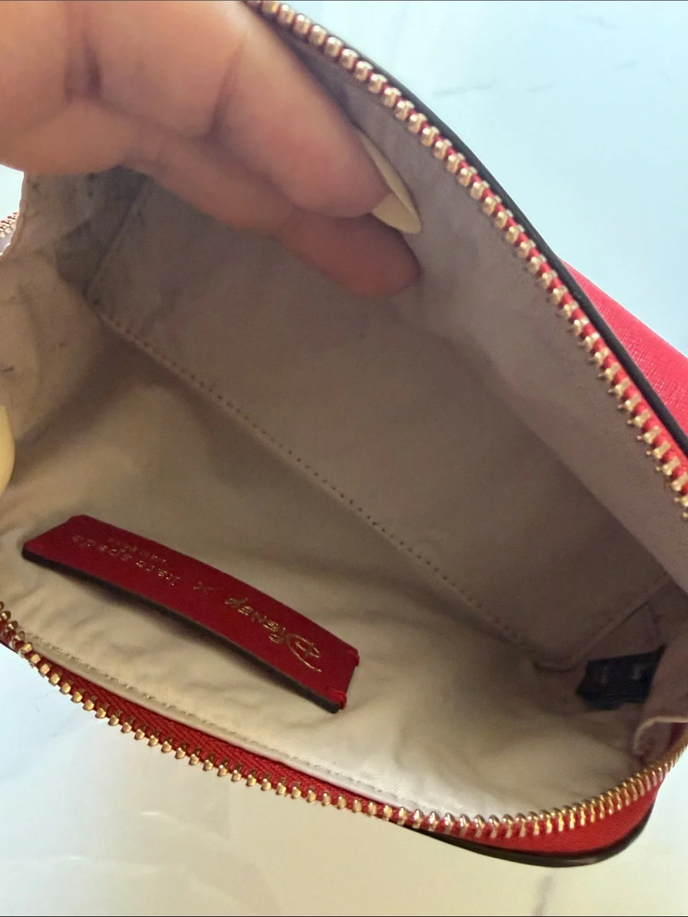 kate spade Red and Cream Cruella Cosmetic Pouch with Gold Logo